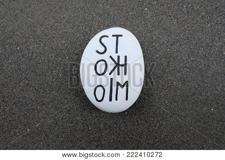 Stockholm Text Carved On A Stone Over Black Volcanic Sand