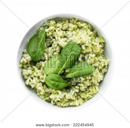 Dish with delicious spinach risotto on white background