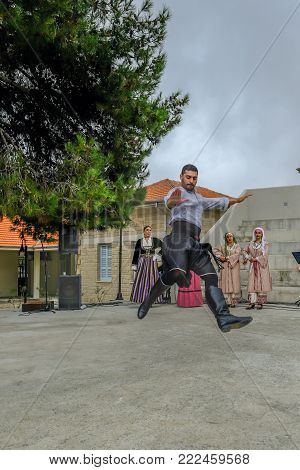 Arsos Village, Cyprus - October 8, 2017: Man dressed in traditional clothing performing folk dance, zebekiko, at a festival.