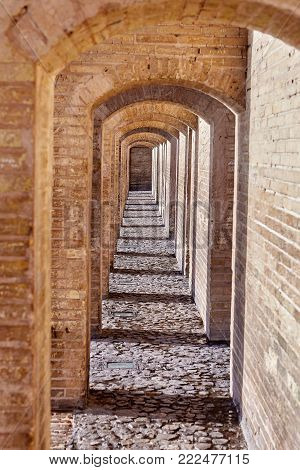 Isfahan, Iran - Brick arched passage inside the stone bridge Khaju.