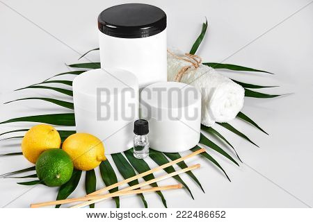 White bottles and two whole lemon and lime isolated on white background. The concept for advertising cosmetics. Still life. Copy space