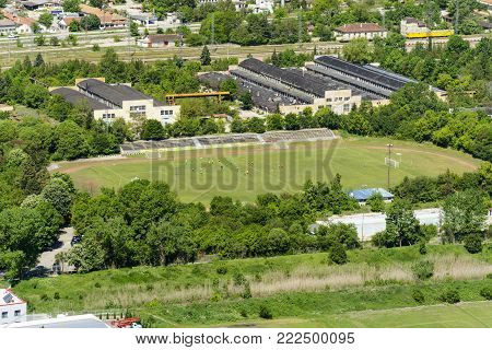 aerial view of the Provadia football stadium with players , surrounded by warehouses