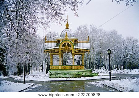 19th Century Historical Monument of Architecture Elegant and Intricate Carved Wood Gazebo Altanka which is a Symbol of the City of Sumy in Ukraine on a Frosty Winter Day Located in the Park