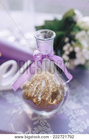 glass vase with gold sparkles for the wedding