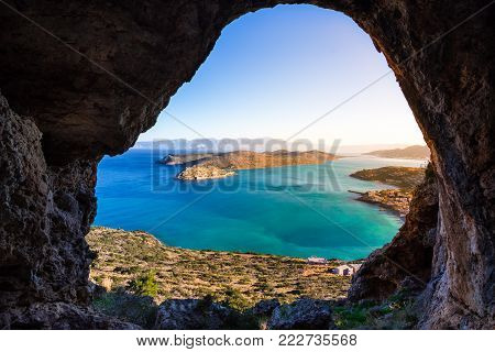 Panoramic view of the gulf of Mirambello with Spinalonga island. View from the mountain through a cave, Crete, Greece.