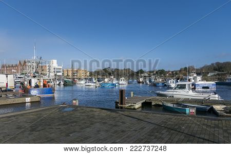 LYMINGTON, NEW FOREST, HAMPSHIRE, UK, JANUARY 2018 - View of the harbour and boats at Lymington, New Forest, Hampshire, UK
