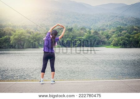 Attractive young muscular women, Athletic woman doing some stretching exercises warm up before start running.