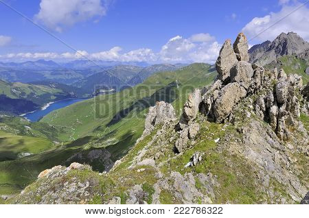 rocky peaks in montain with view on a lake in summer