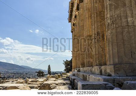 View of the Parthenon columns on the side with the city of Athens background