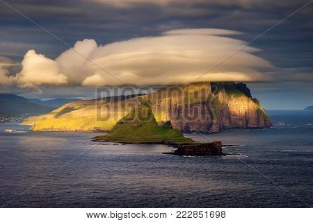 Amazing clouds over Tindholmur and Vagar islands in sunset light, Faroe Islands