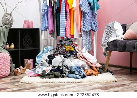 Messy dressing room interior with clothes rack