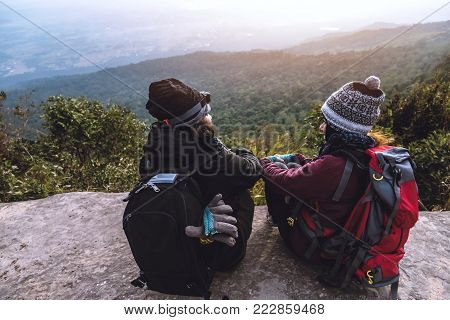 Lover women and men asians travel relax in the holiday. Admire the atmosphere landscape on the Moutain. Mountain Park happily. In Thailand