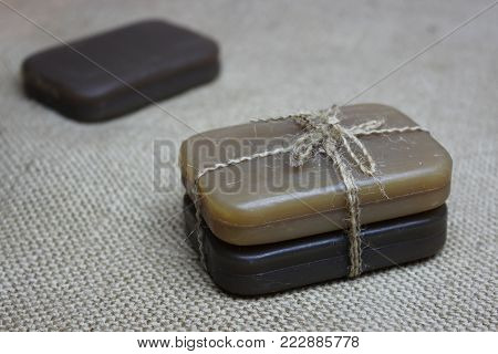 Natural tar handmade soap lies on linen fabric