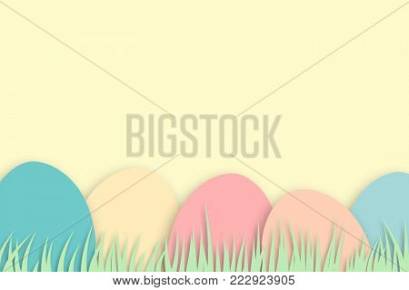 Pastel colored minimal easter design with colored easter eggs and grass on background with copy space