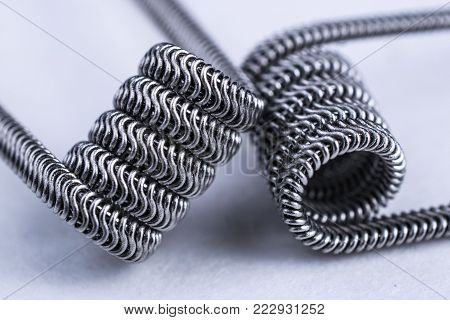 pare of vaping coils for electronic cigarette or e cig and vape devices on white background