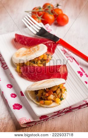 tigelle with bresaola and vegetables, selective focus