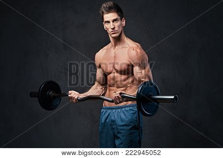 Athletic shirtless male biceps barbell workout over grey background.