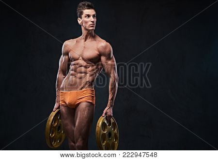 The shirtless athletic ectomorph male holds barbell weights in arms.