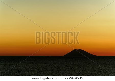 Volcano 'Stromboli' at sunset. 'Stromboli' is an active volcano island in Italy. This photo was shot from the city Tropea