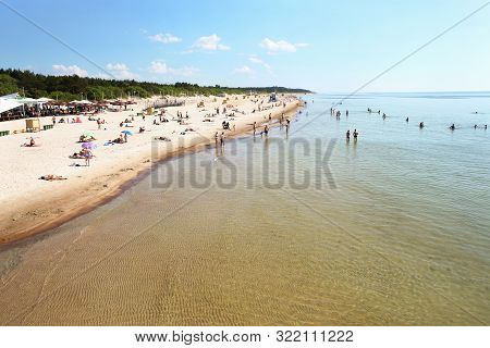 Palanga, Lithuania - Julne 5, 2018: People Are Relaxing On Sandy Beach Of  The Baltic Sea. Seaside R