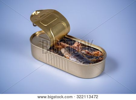 Open Canned Food With Smoked Herring On A Gray Background