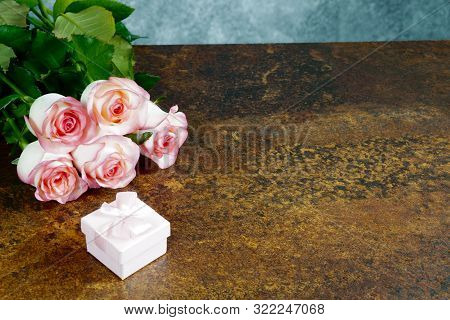 Roses On Rusty Table With Gray Background