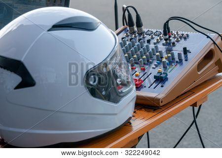 Helmet On The Background Of The Sound Console. Sound Test For The Concert. Mixer Control. Musical En