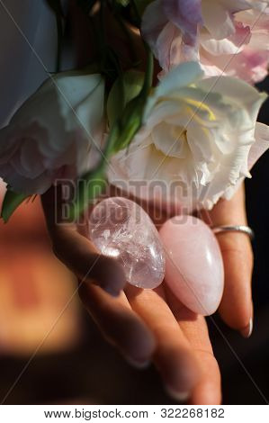 Female Hands Holding Two Yoni Eggs For Vumfit, Imbuilding Or Meditation Are Made From Pink Quartz An