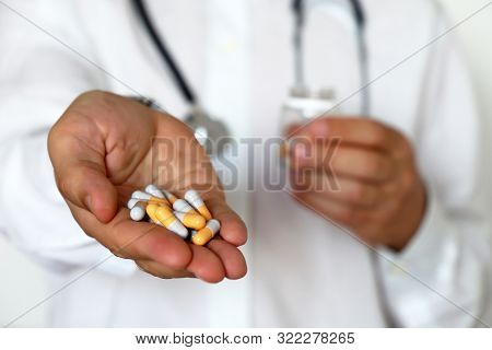 Doctor Giving Pills, Physician Holding In Palm Of Hand Medication In Capsules. Concept Of Dose Of Dr