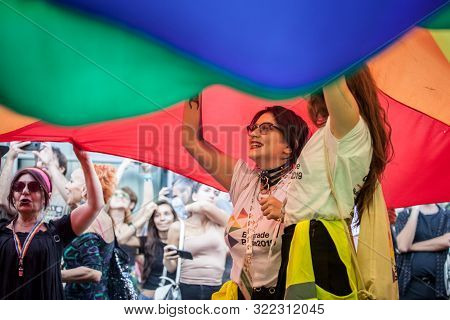 Belgrade, Serbia - September 15, 2019:  Two Young Girls Standing Under A Giant Rainbow Gay Flag Duri