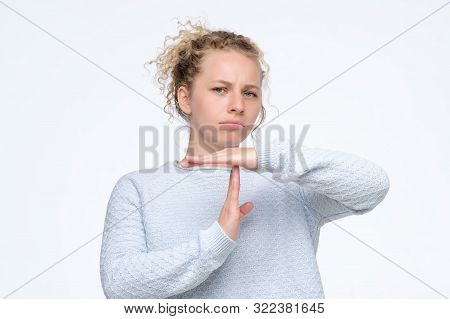 Blonde Curly Woman In Blue Sweater Making Time Out Gesture