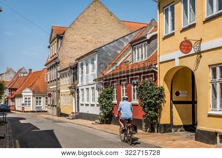 Picturesque  Street In Faaborg With Old Houses And Hollyhocks On The Pavement, Faaborg, Denmark, Jul