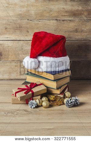 A Stack Of Books, Santa Clauss Cap, An Alarm Clock, Cones, Christmas-tree Decorations, Gift Boxes On