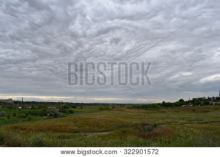 Landscape With Sky Covered With Bizarre Clouds. Association With The Eye. The Concept Of The Rorscha