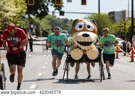 Lawrenceville, Ga/usa - April 27:  A Team Pushes A Bed Designed To Look Like Slinky Dog From Toy Sto