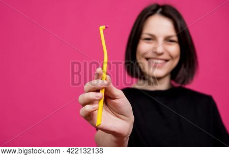 Beautiful Happy Young Woman With Single Tufted Toothbrush On Blank Pink Background