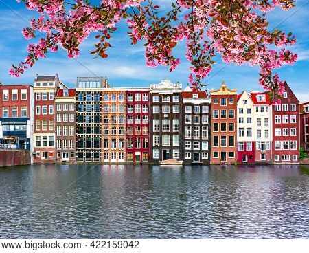 Traditional Amsterdam Architecture On Damrak Canal In Spring, Netherlands