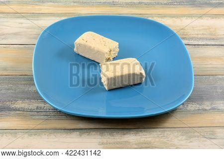 Two Pieces Of Vanilla Tahini Halvah Snack On Blue Snack Plate