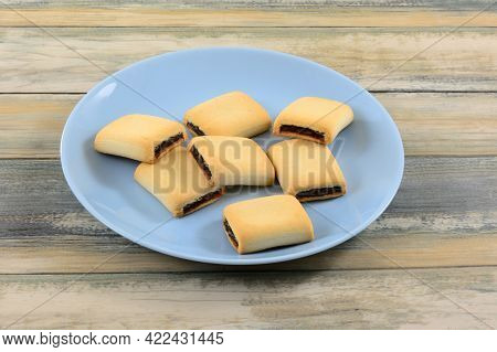 Date Filled Maamoul Cookies On Blue Snack Plate On Table