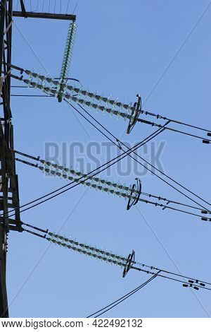 Power Line Of Cables And Insulators Close Up. Electrical Insulators Support Cables Placed On Bracket
