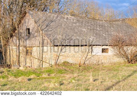 Old Barn Near Trees At Spring On A Sunny Day. Old Farm