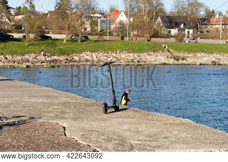 Electric Scooter On The Wharf Overlooking The Sea. Baltic Sea. Sunset