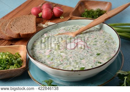 Cold Soup Okroshka With Sausage, Potato, Egg, Radish, Cucumber, Greens And Kvass In A Bowl, Bread On