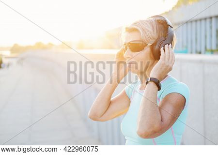 Active Seniors Woman Listen Music After Fitness Workout In The City