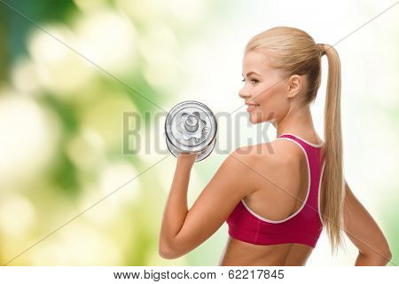 fintess, healthcare and dieting concept - young sporty woman with heavy steel dumbbell