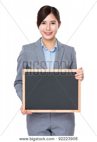Businesswoman show with blank black baord