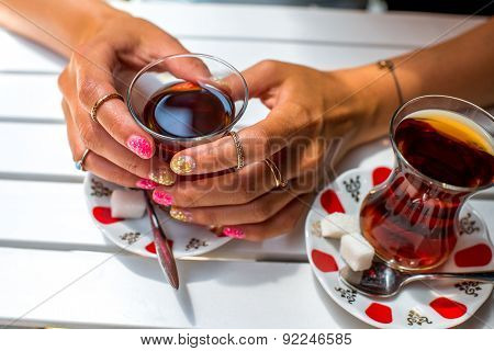 Holding turkish tea in traditional teacup