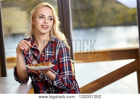 Woman in home eating breakfast