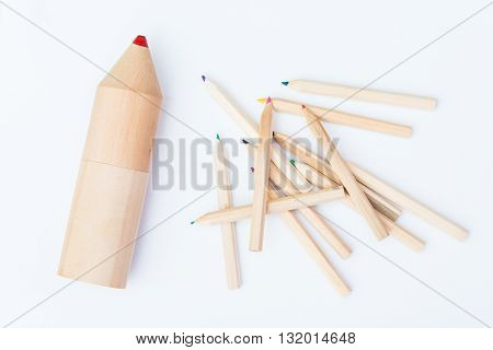small pile of crayons and one huge crayon