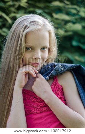 Portrait of a beautiful blonde little girl with long hair